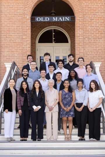 Pat Gerleman with the first class of Gerleman scholarship recipients standing and smiling on the steps of Old Main.