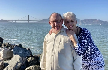 Pat and James "Jim" Anthony Gerleman standing and smiling next to the Golden Gate Bridge