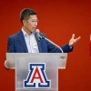 Michael Wu standing and speaking into a microphone, while standing in front of a podium with a "Block A" on it. 